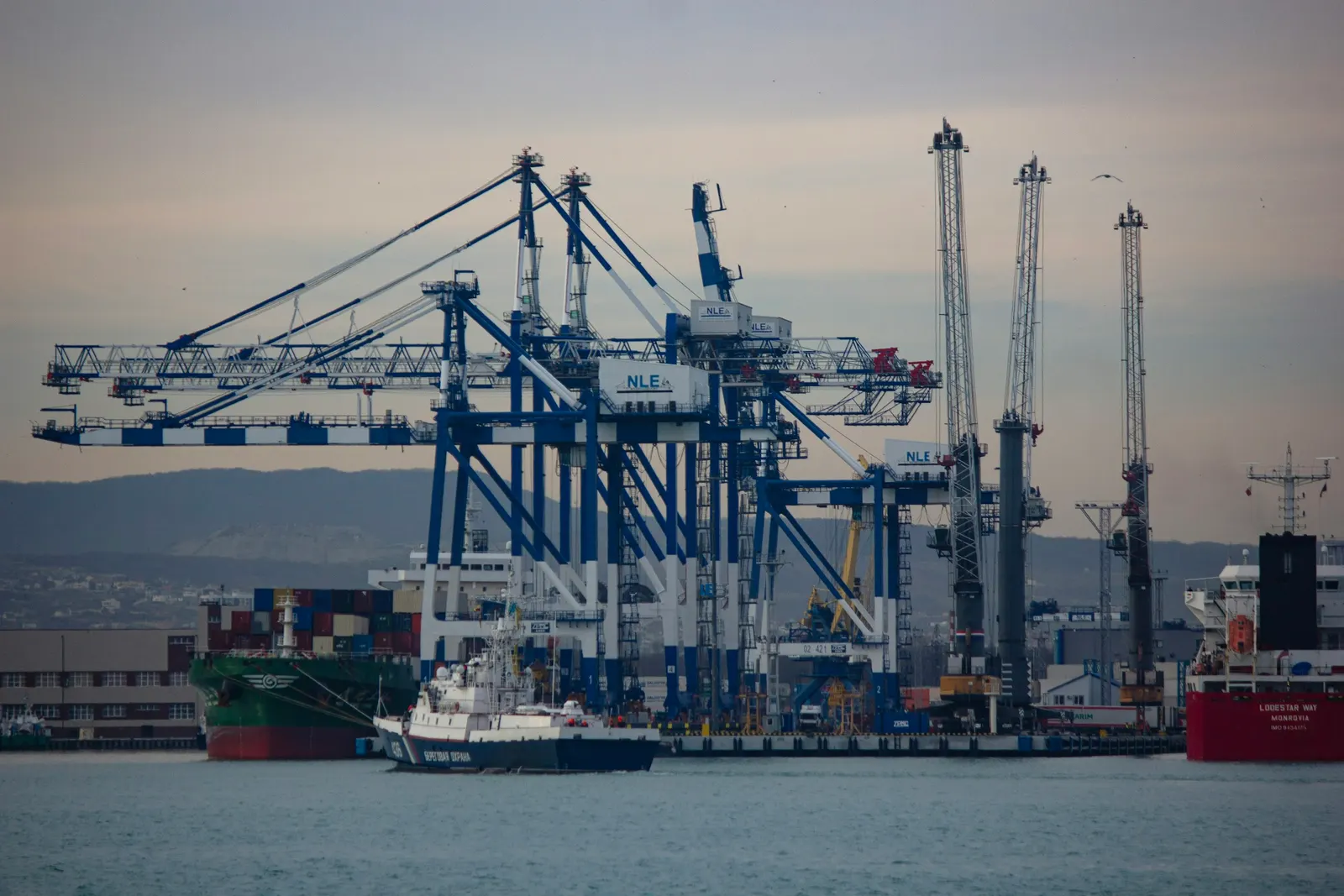 Container cranes and a cargo ship at a port